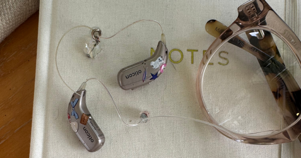 headphones and glasses on top of a journal
